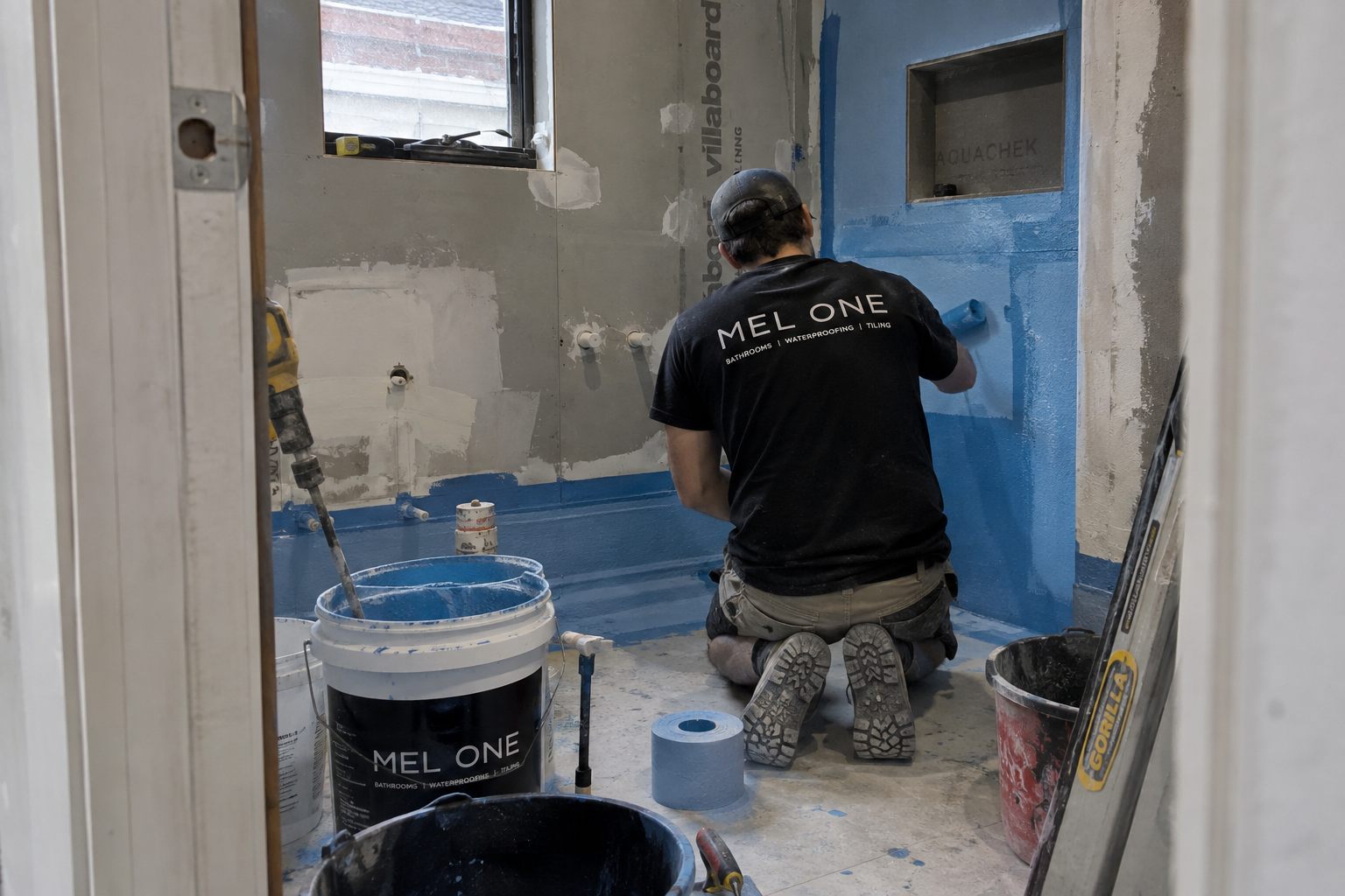 MEL ONE applying waterproofing membrane in a bathroom